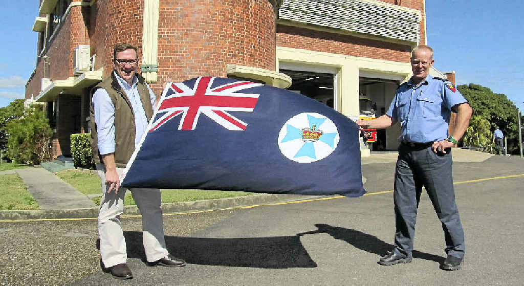 Gympie MP David Gibson presented Gympie Fire and Rescue Service’s senior firefighter Kyle Dellit with a new Queensland flag. Gympie MP David Gibson presented Gympie Fire and Rescue Service’s senior firefighter Kyle Dellit with a new Queensland flag.